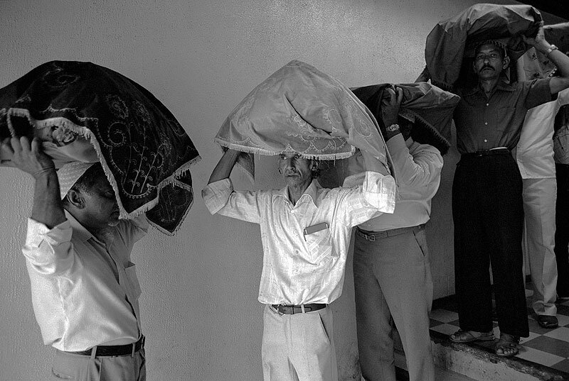 Devotees carrying offerings. Badsha Pir birthday celebrations. Victoria street. 1980