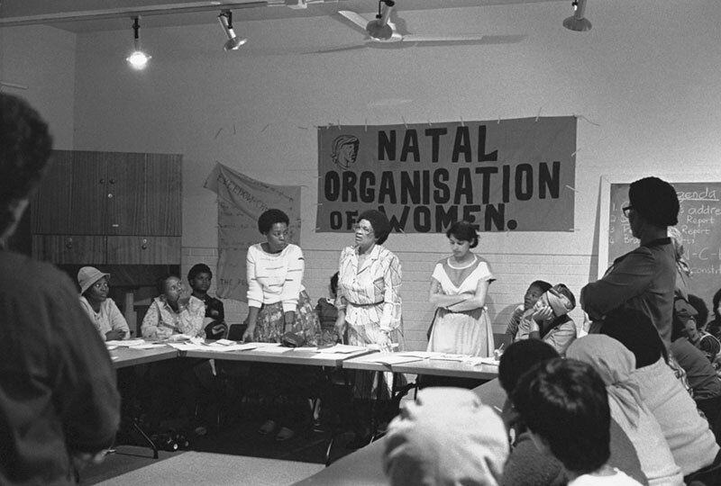 Mrs. Sisulu and newly elected executive members, Nozizwe Madlala and Hershella Narsee at NOW founding conference. Diakonia Centre. 1983