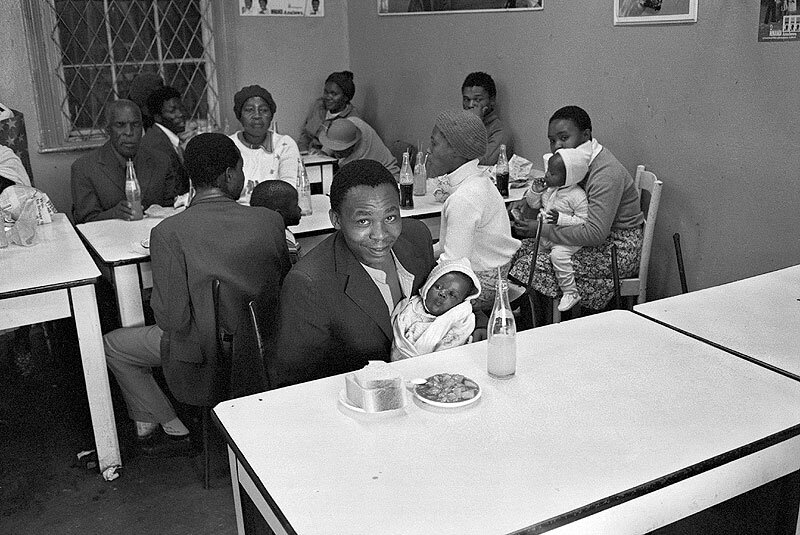 Migrant worker with son, Patel's refreshment house. Brook street. 1984