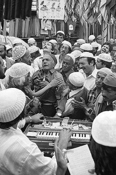 Devotees go into a trance. Badsha Pir birthday celebrations. Victoria street. 1980