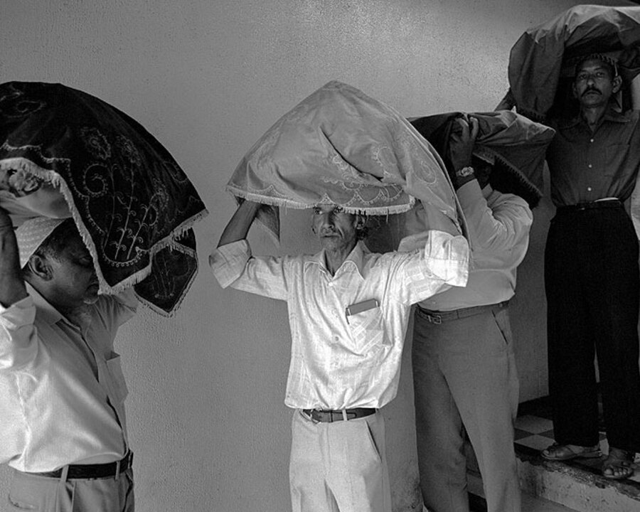 Devotees carrying offerings. Badsha Pir birthday celebrations. Victoria street. 1980