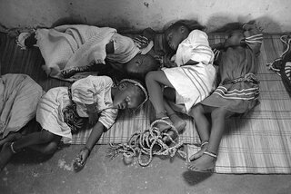 Children asleep after all night vigil. 1982