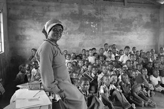Teacher with her class of eighty children. Amouti